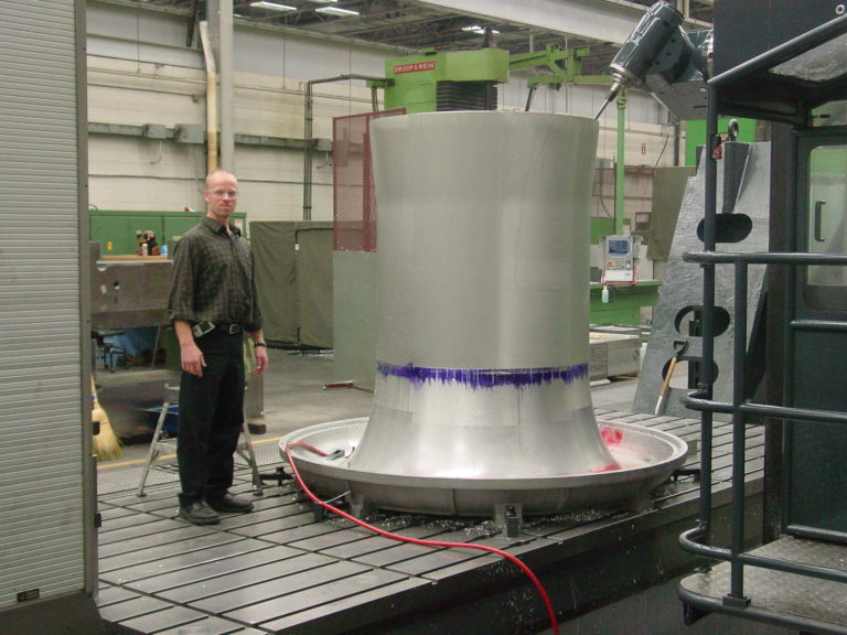 Paragon employee standing besid bell mouth